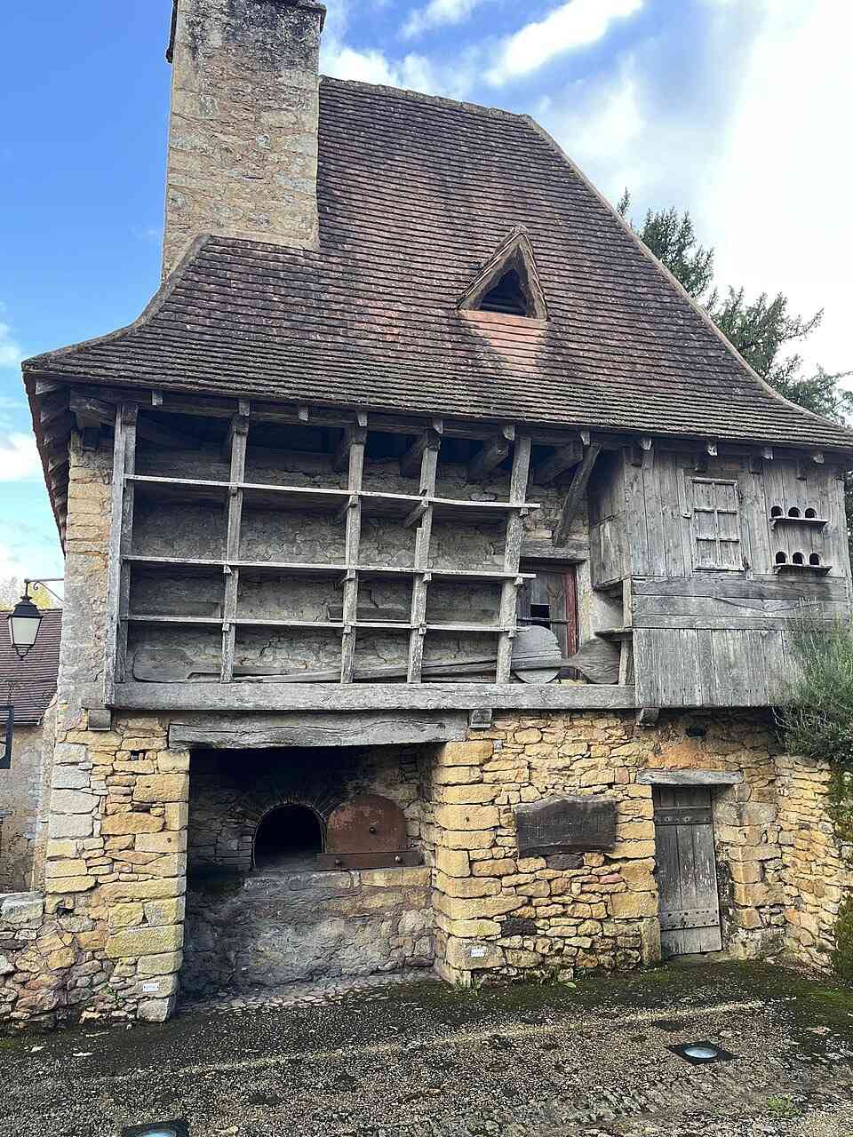 Medieval four banal communal bread oven in Urval Dordogne France dating from the 14th century with stone base and timber upper structure